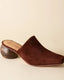 Brown suede slip-on shoe on a beige background